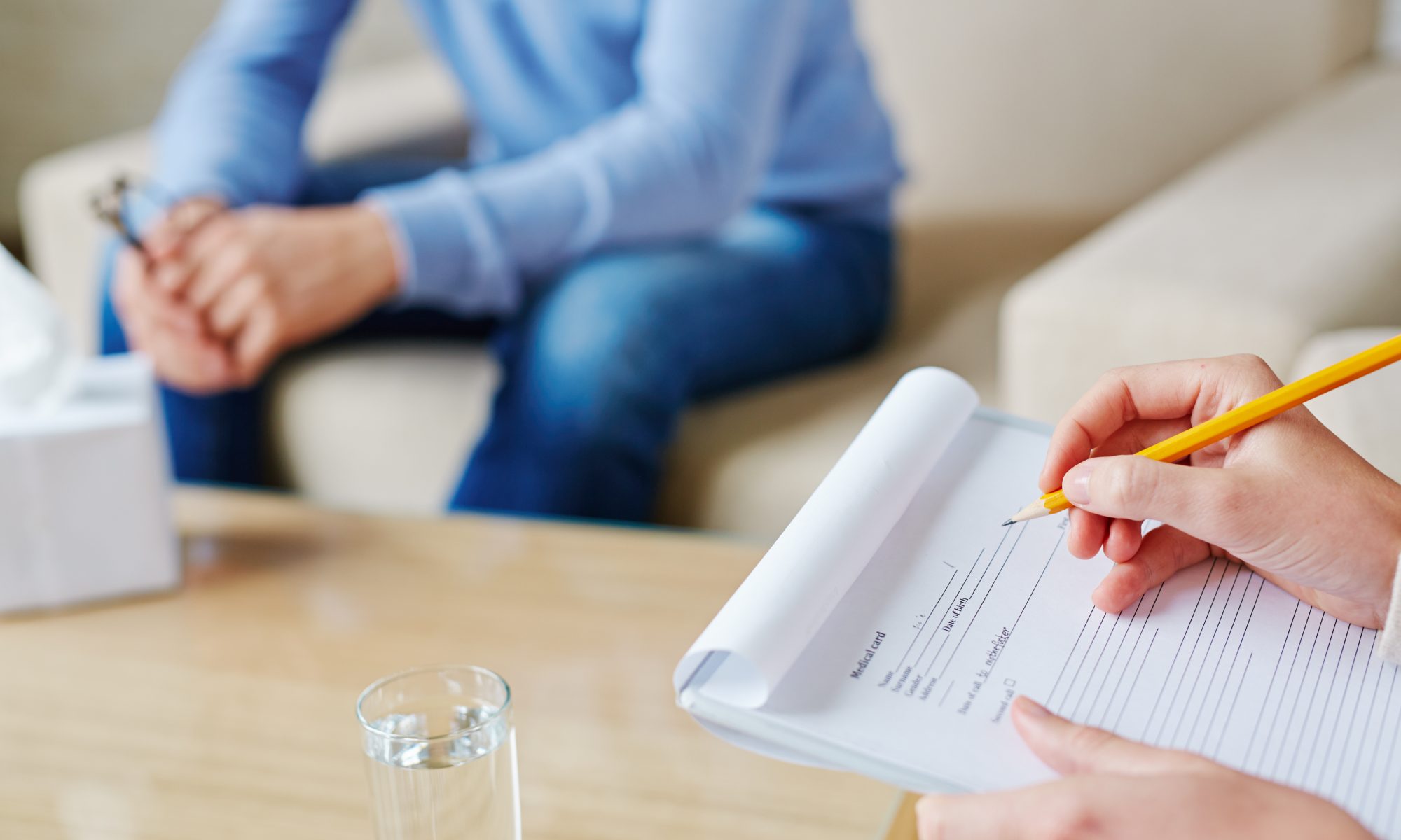 Processing of filling in medical card of depressed patient in psychologist office, close-up shot